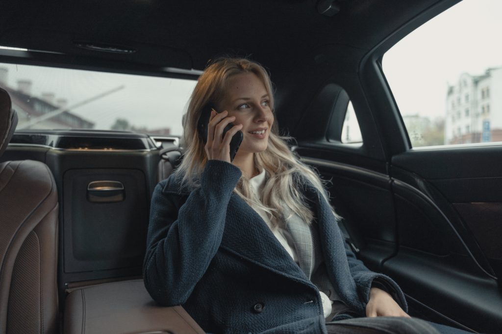 WOman in the back of a car on the phone
