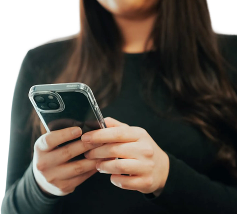 Business professional using a smartphone in a office setting.