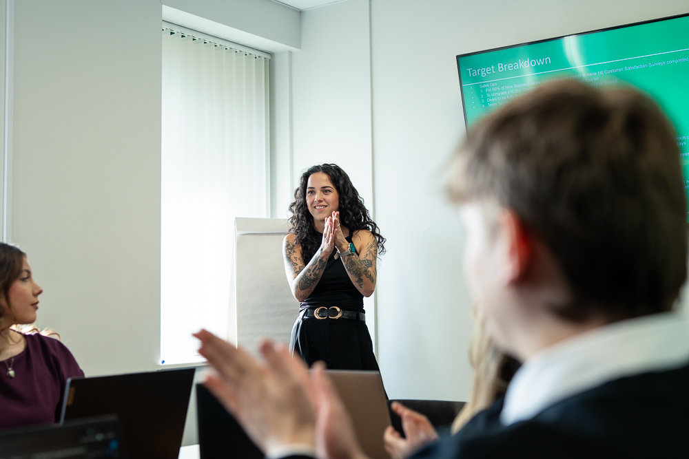 Associated Telecom team member speaking during an office presentation.