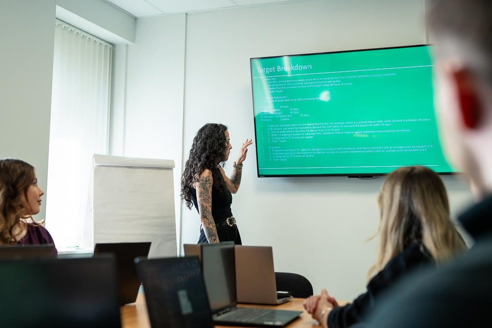 Staff presentation in a modern office meeting room.