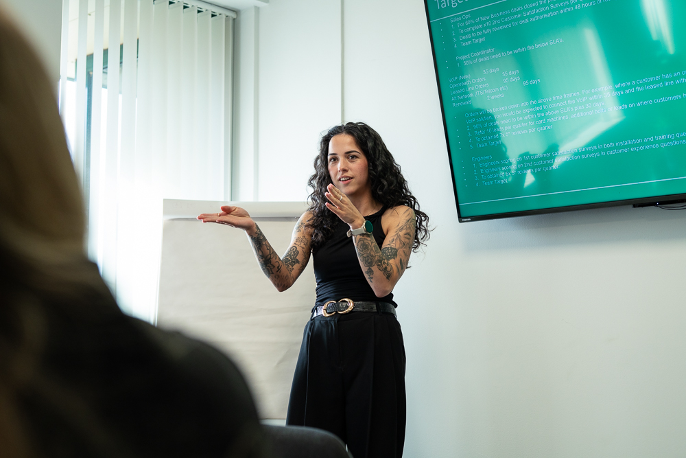 Associated Telecom team presentation in a modern meeting room.