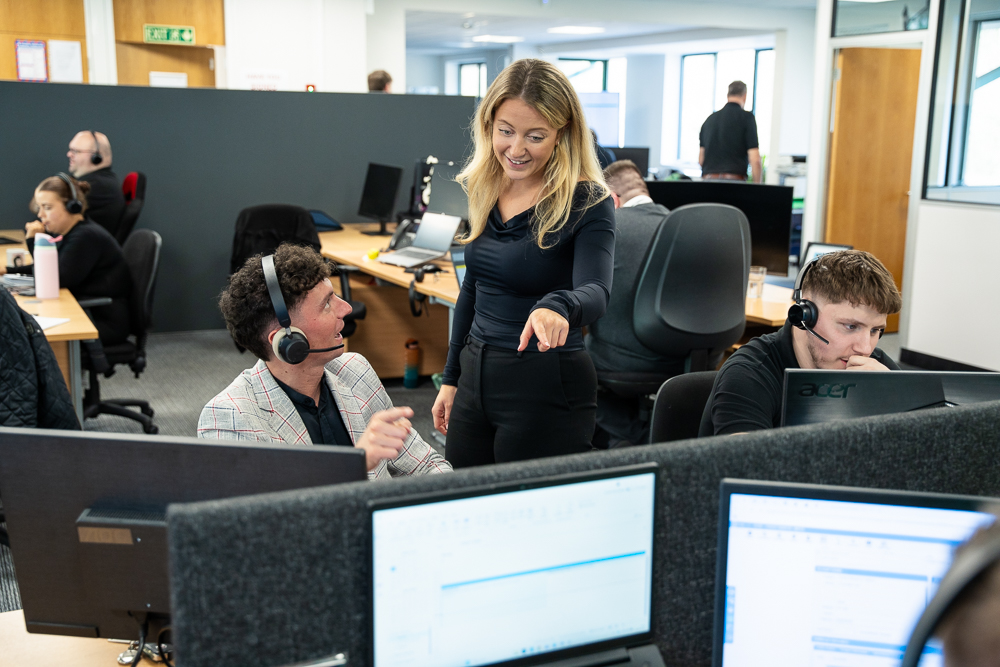 Office team collaborating on business connectivity and telecom services.