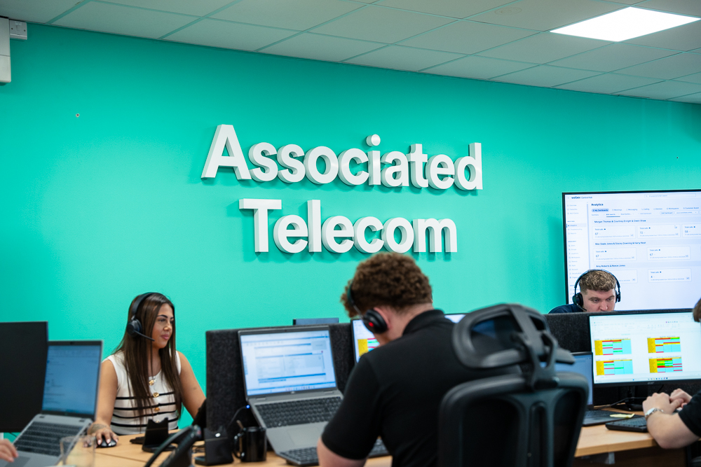 Telecom staff at work in a branded office workspace.