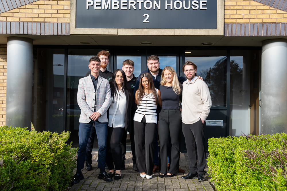 Team group photo outside Pemberton House entrance.
