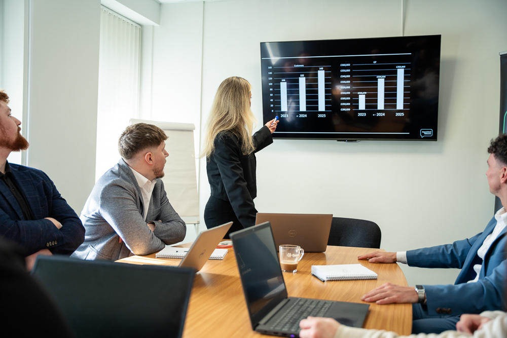 Associated Telecom business team collaborating around a conference table.