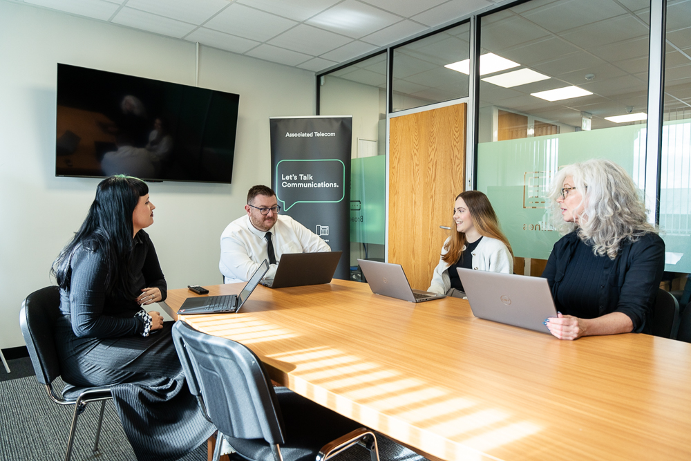 Business team discussing work around a conference table.