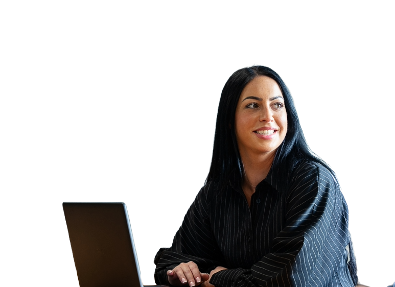 Female business professional using a laptop in a modern office for team communications.